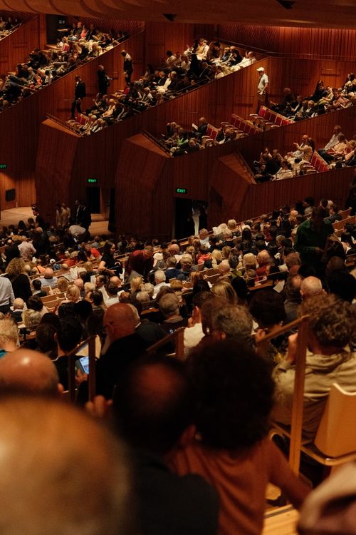 Free A large crowd of people attending a concert in the iconic Sydney Opera House. Stock Photo