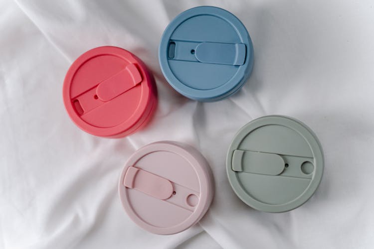 Colorful Silicone Cup Lids On White Surface