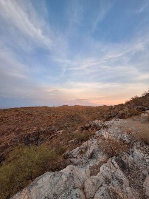 Free Beautiful desert vista with rocky terrain and colorful sky at sunrise. Stock Photo