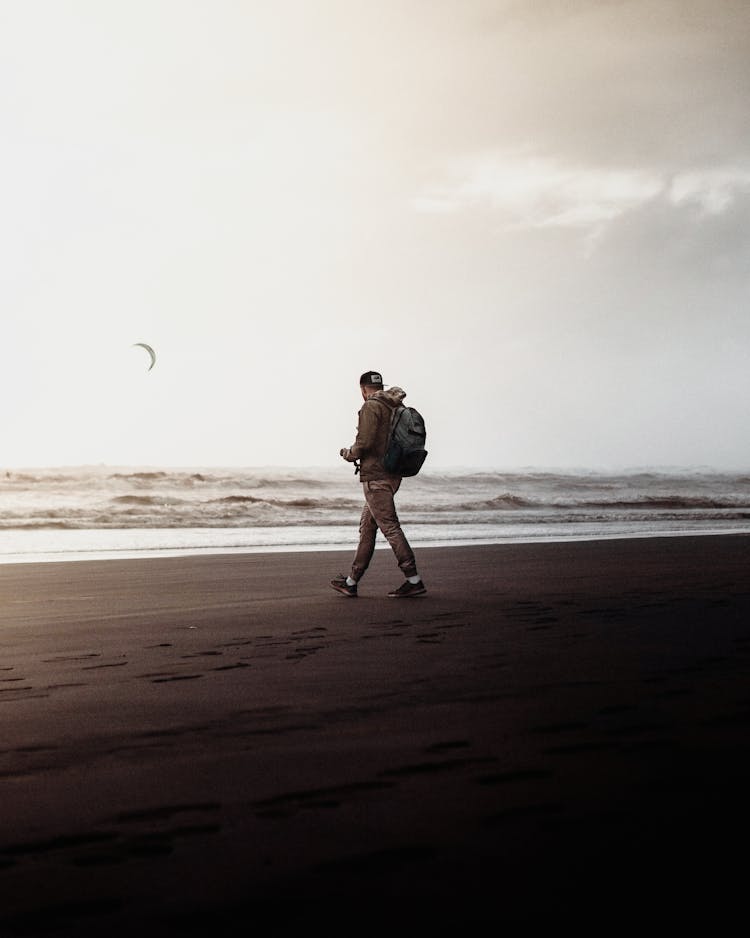 Man Walking On Beach