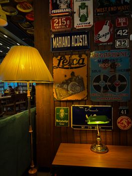 Warm, vintage café interior in Ankara with retro signs, lamps, and wooden elements.
