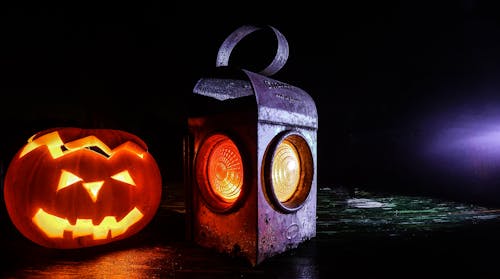 Jack O'lantern Beside Black Lantern