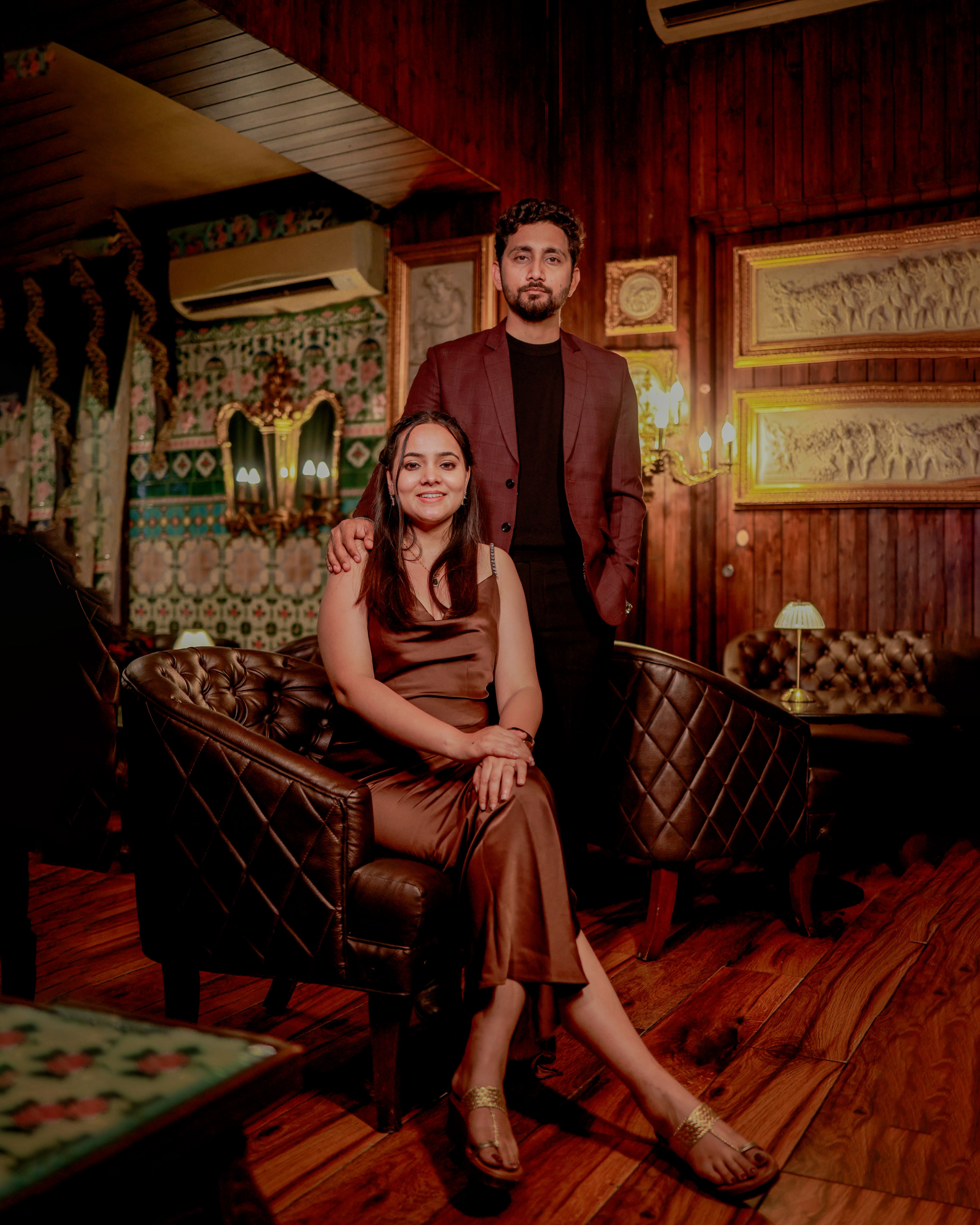 Stylish pre-wedding shoot featuring an Indian couple in an elegant indoor setting.