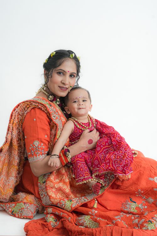 Free A mother and her child wearing colorful traditional Indian clothing, posing joyfully. Stock Photo