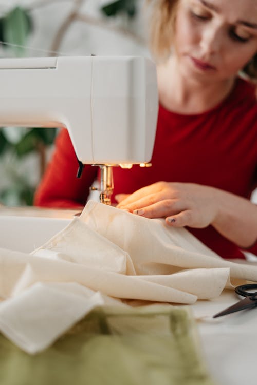 Free Woman Using a Sewing Machine Stock Photo