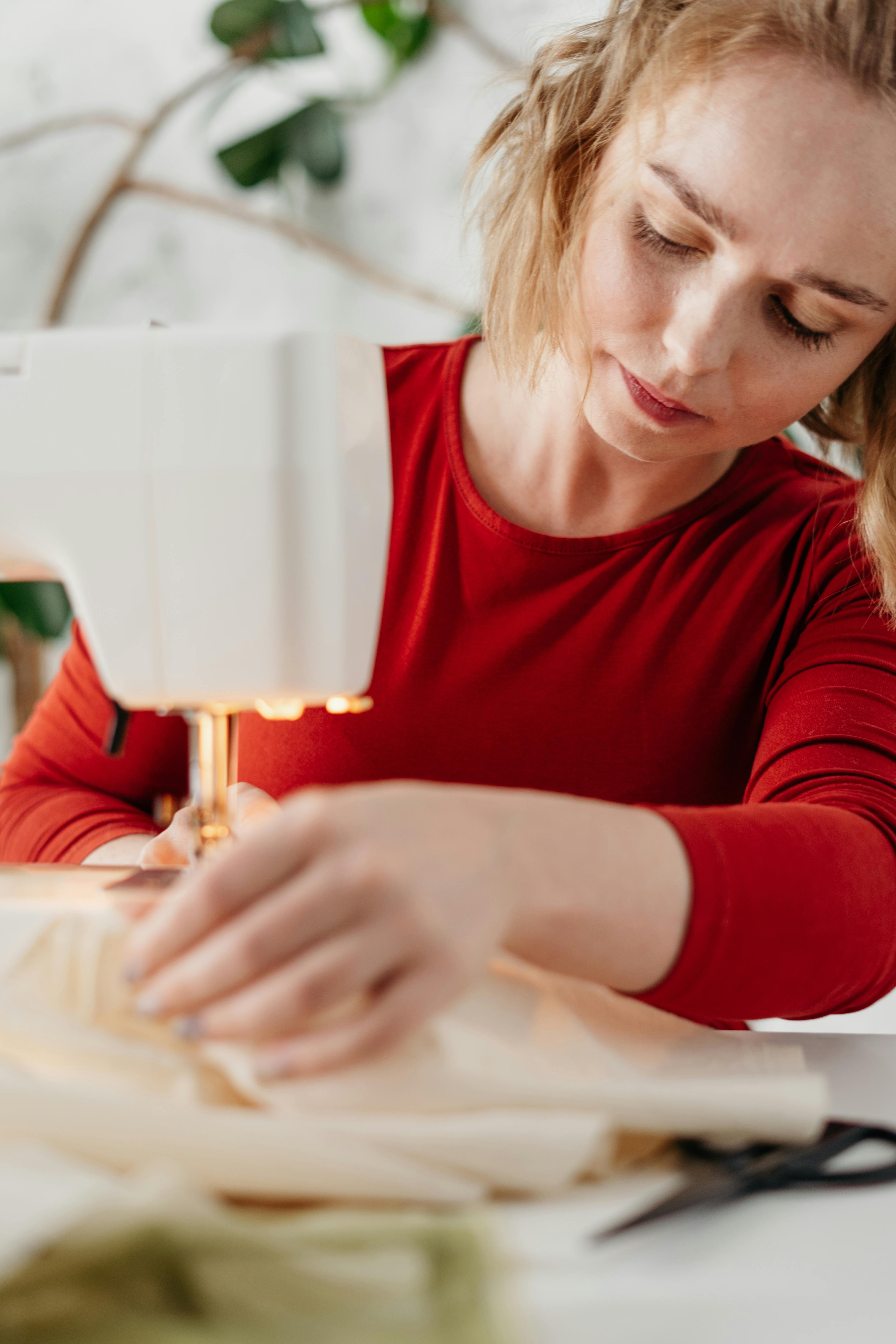 A girl is sewing on a machine. Mom shows how to work with equipment.  Close-up. Stock Photo by ©Alexeg84 314794668