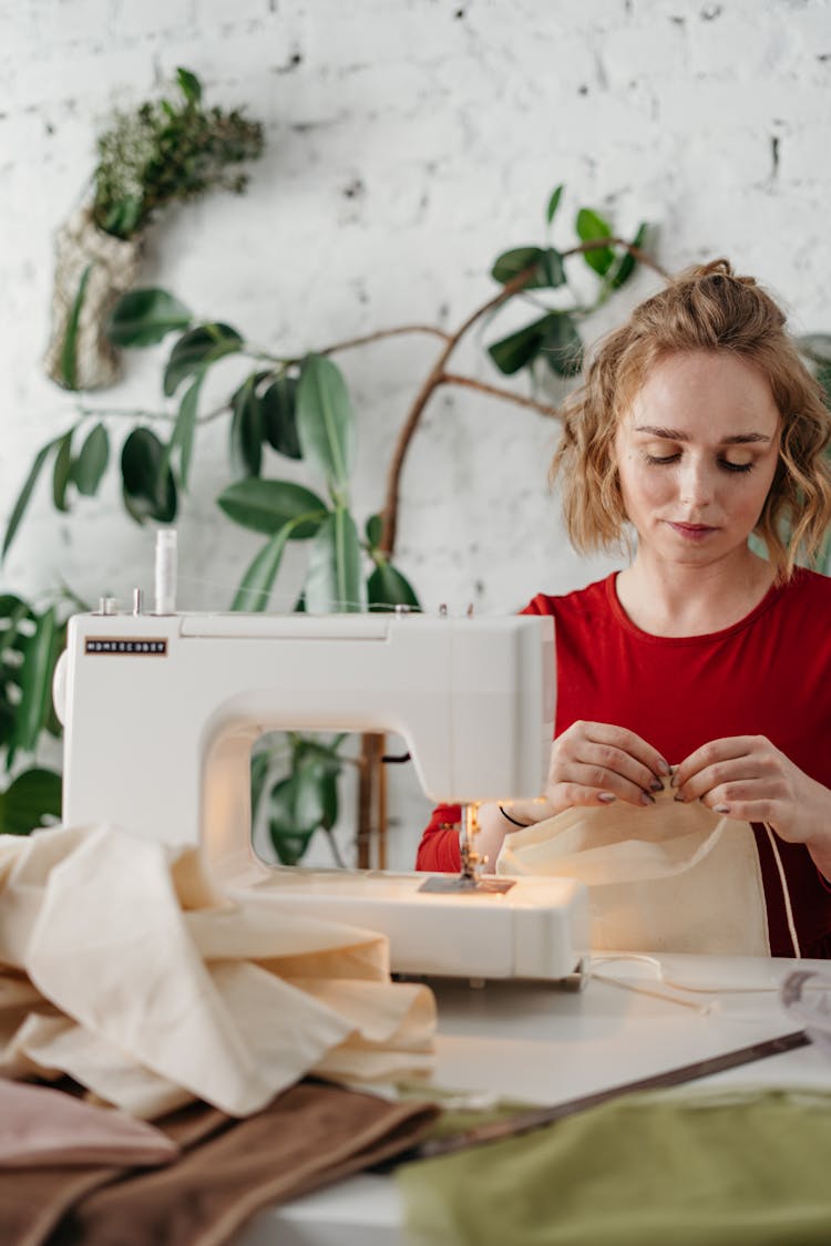 Woman Sewing A Fabric