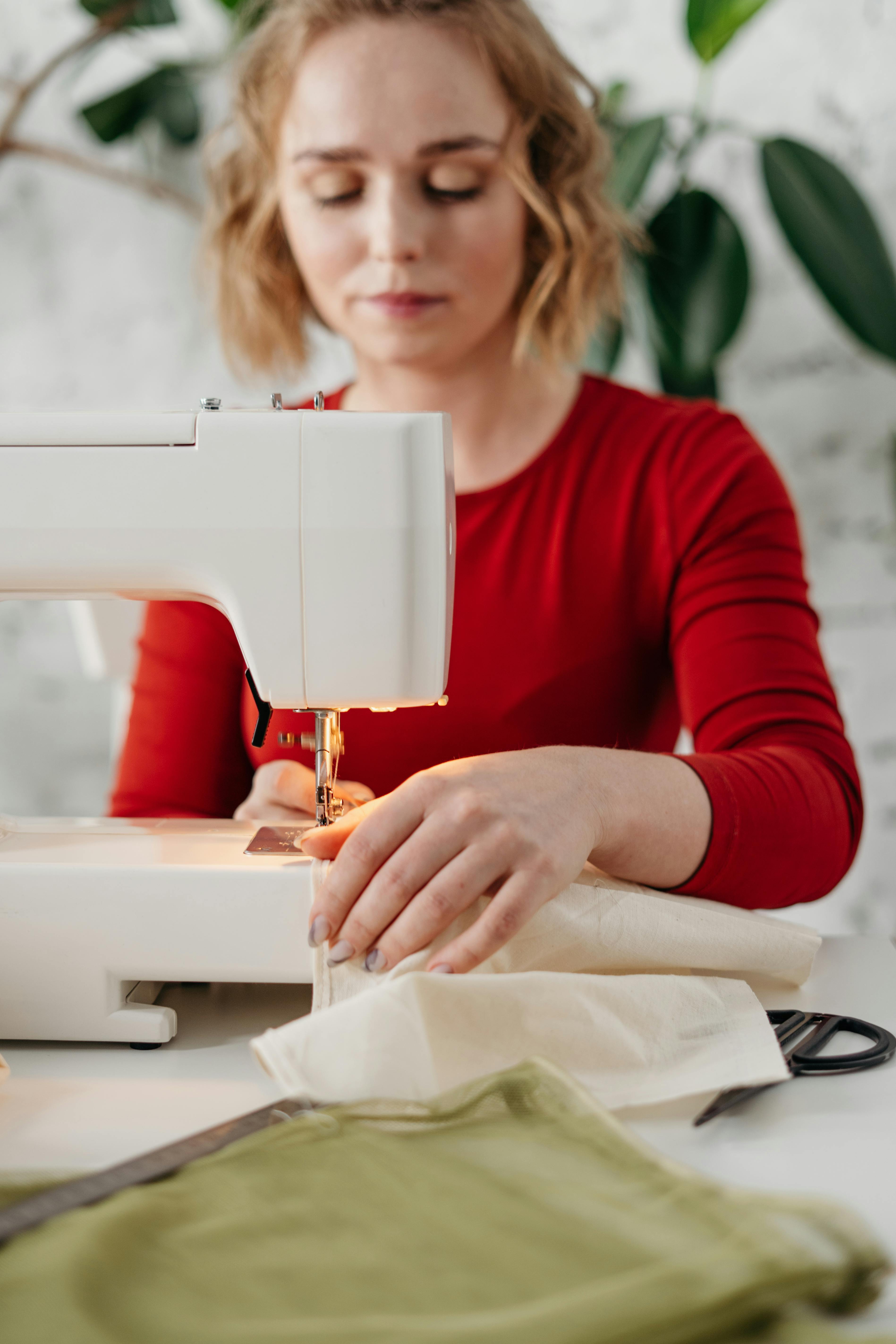 Woman with a thimble sewing stock photo