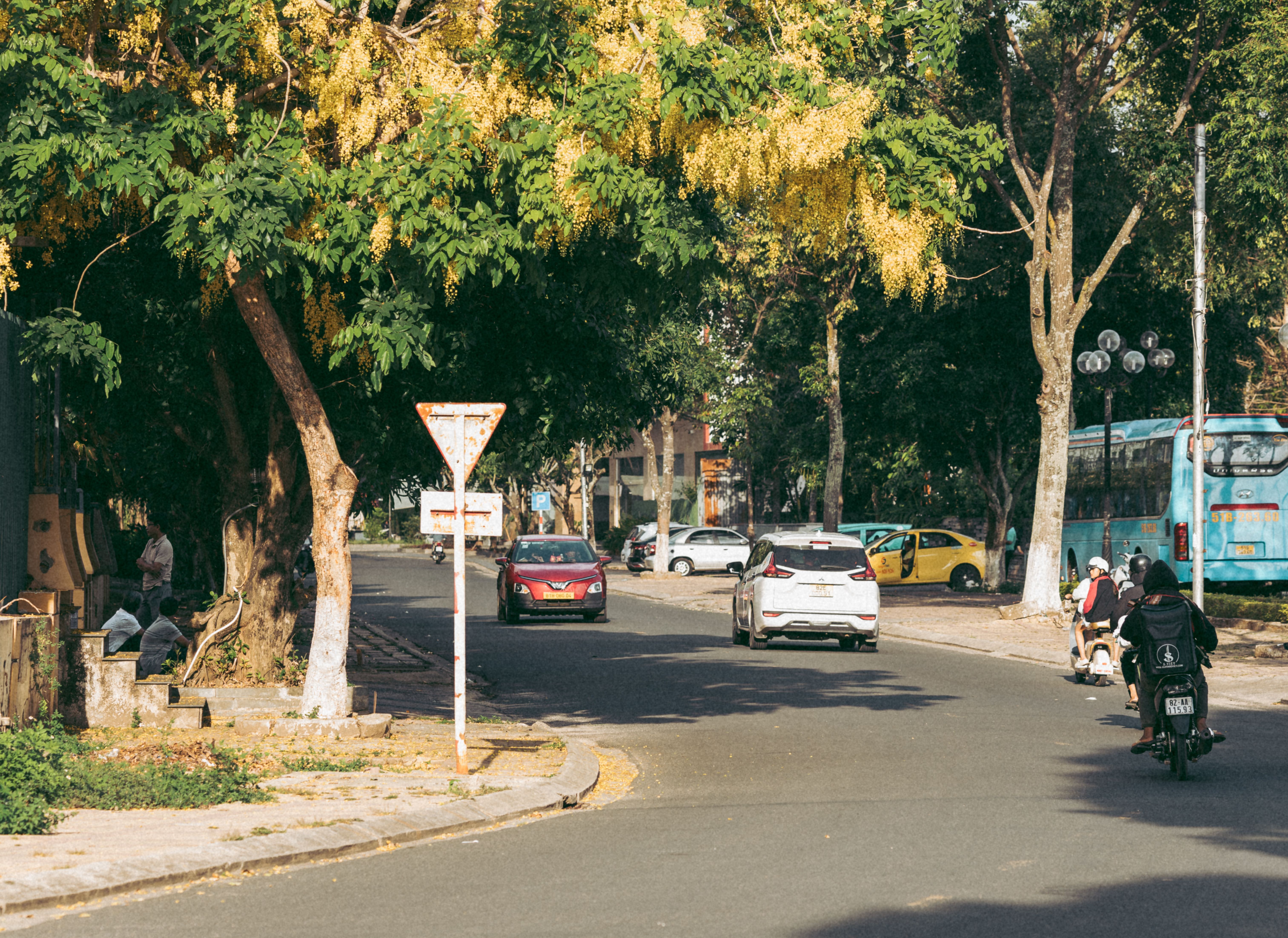 Vibrant afternoon street scene in Kon Tum, Vietnam, showcasing daily life and urban environment.