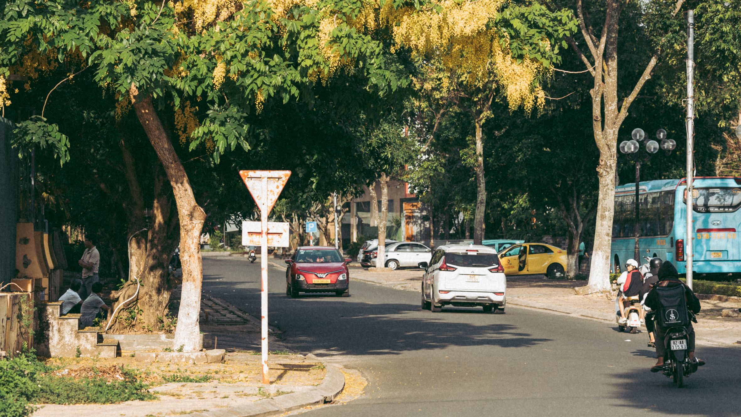 Vibrant afternoon street scene in Kon Tum, Vietnam, showcasing daily life and urban environment.