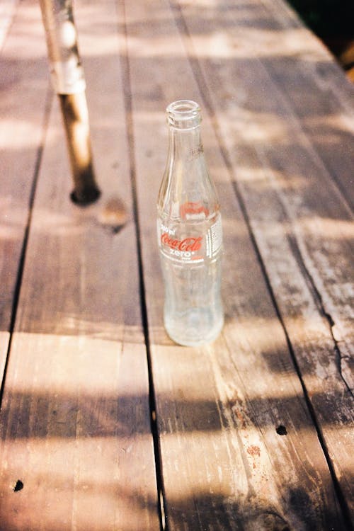 Coca-Cola Glass Bottle on Wooden Surface