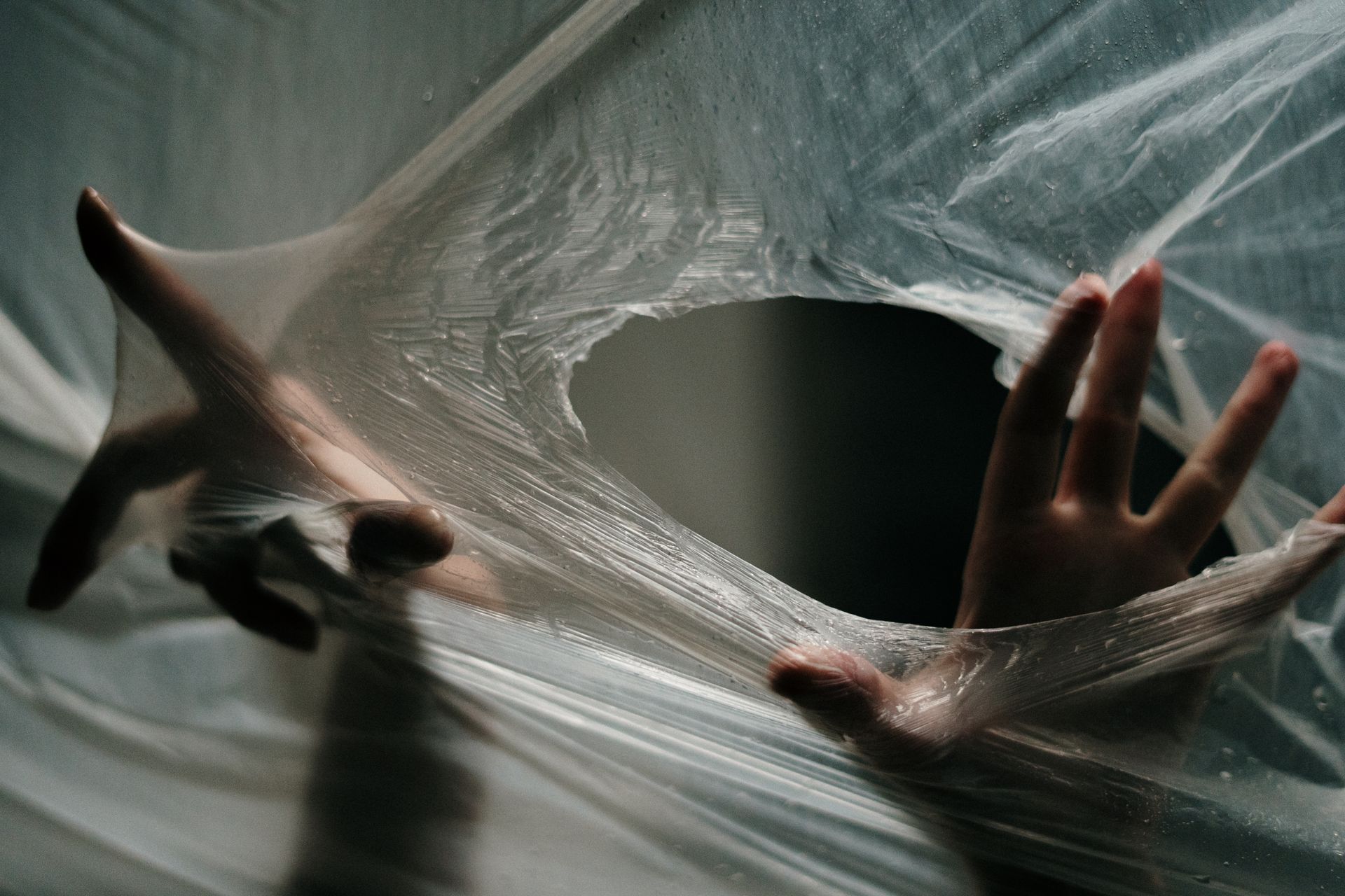 Hands Sticking out from Plastic Wrap