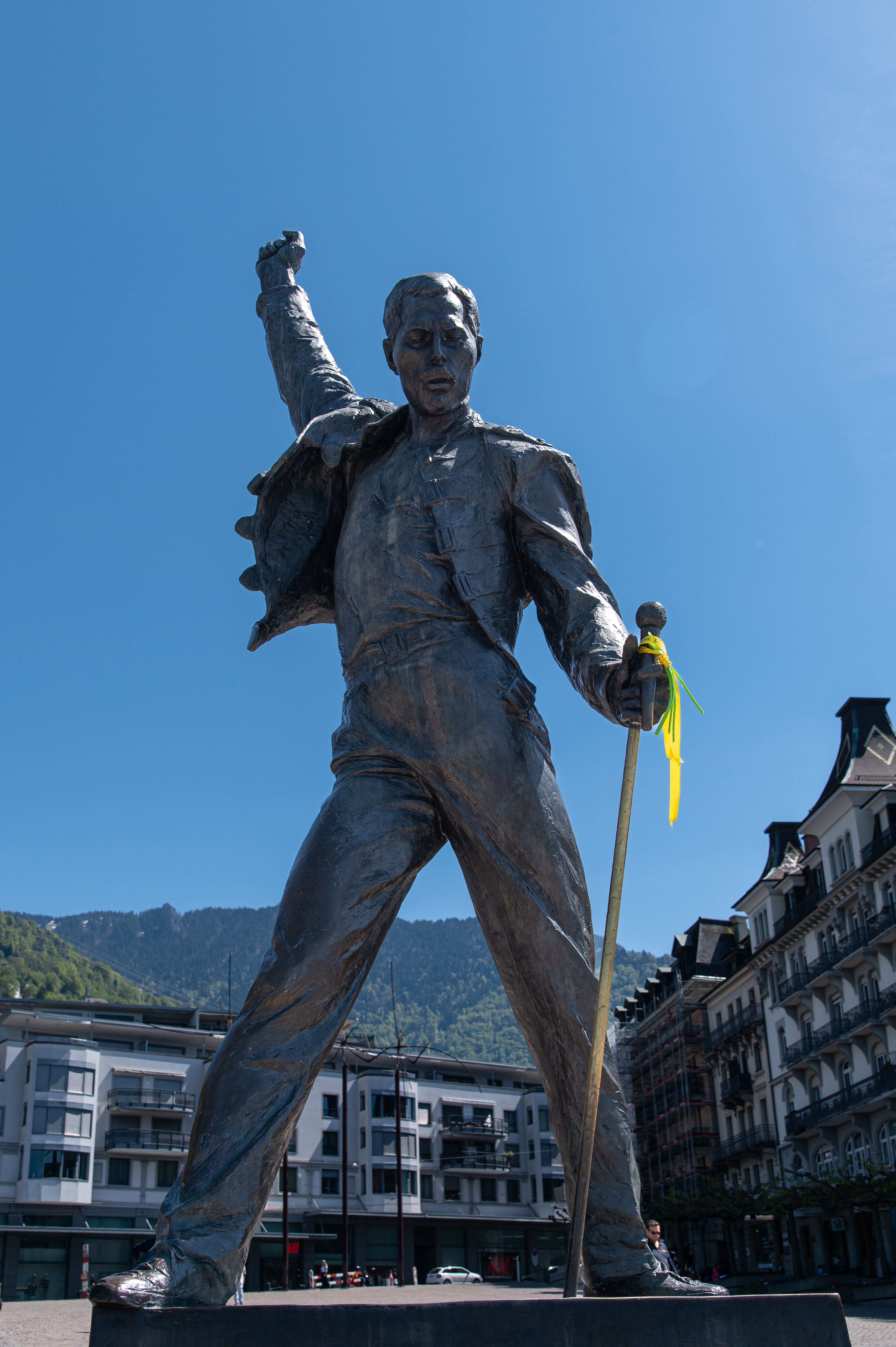 Bronze statue of iconic singer in Montreux, Switzerland, under clear blue sky.