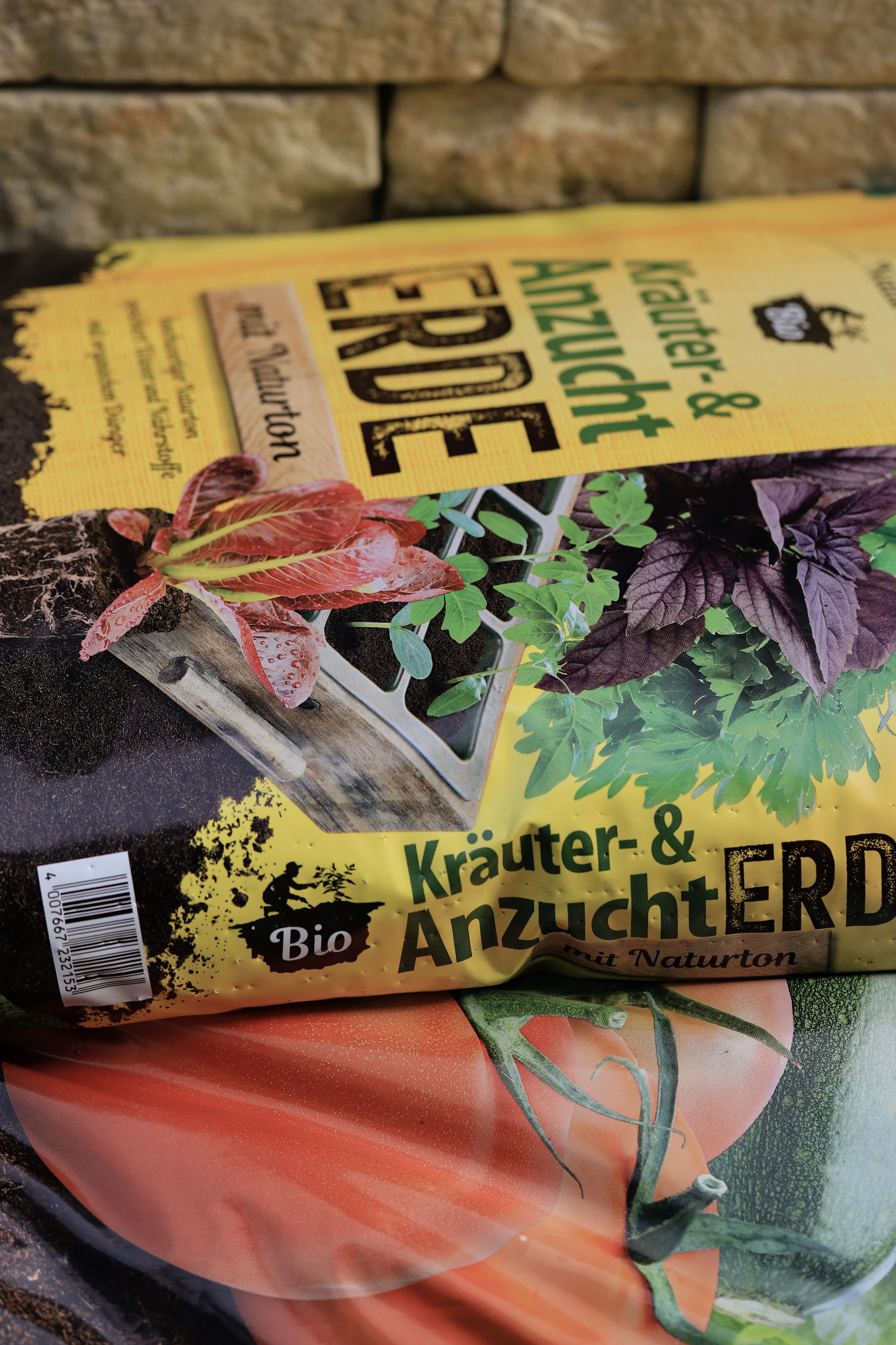 A bio soil bag for herbs and plant cultivation with vibrant vegetable images.