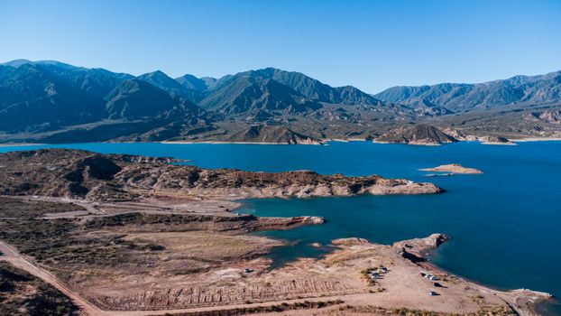 Stunning aerial view of Potrerillos Lake surrounded by mountains in Mendoza, Argentina.