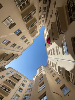 Dramatic upward view of Warsaw buildings forming an open sky shape.