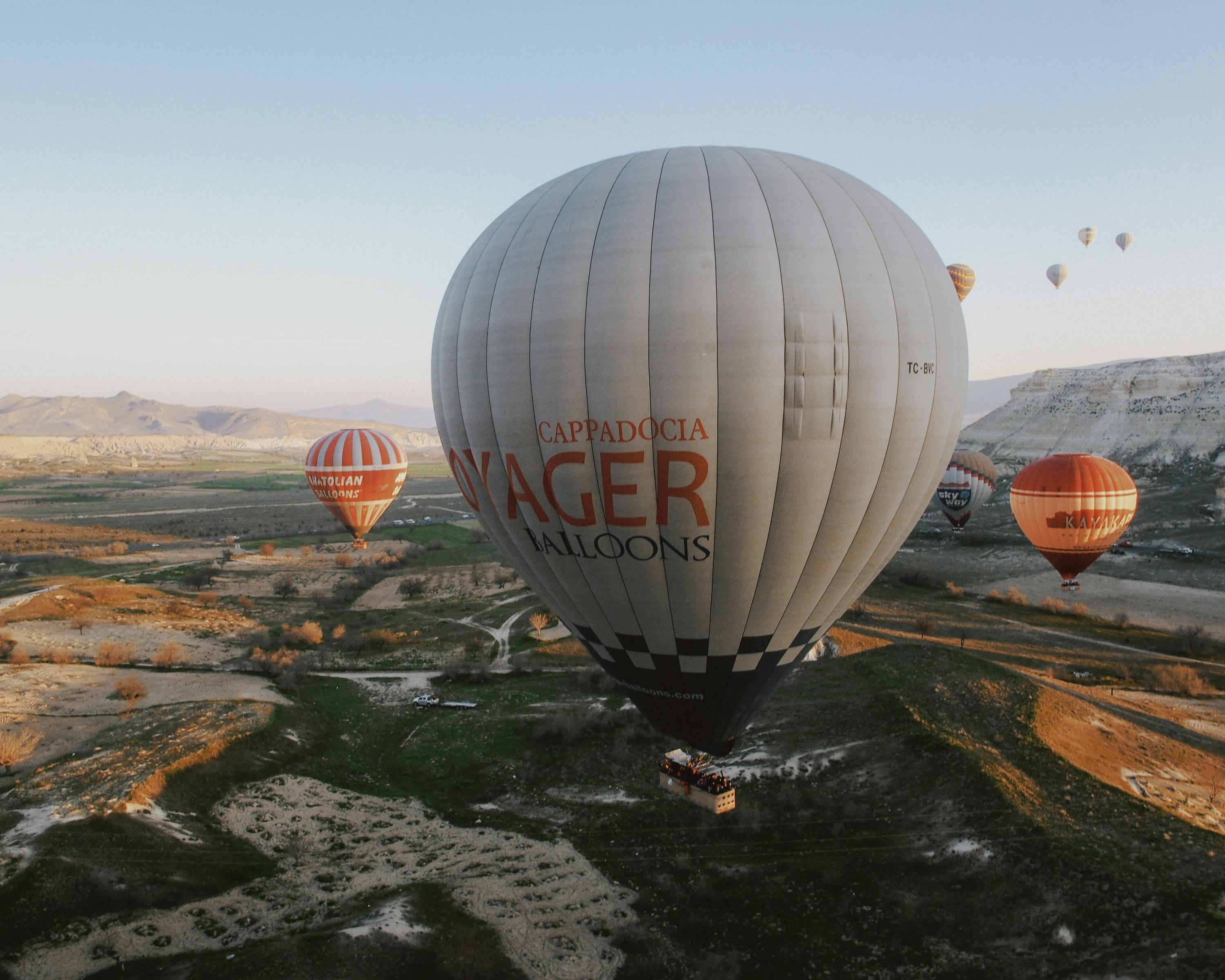 Beautiful view of hot air balloons soaring above Cappadocia's stunning landscape at sunrise.