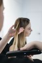 Photo of Person Ironing a Woman's Hair