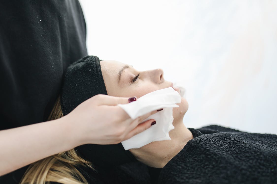 Free Photo of Person Using a Tissue to Dry a Woman's Face Stock Photo