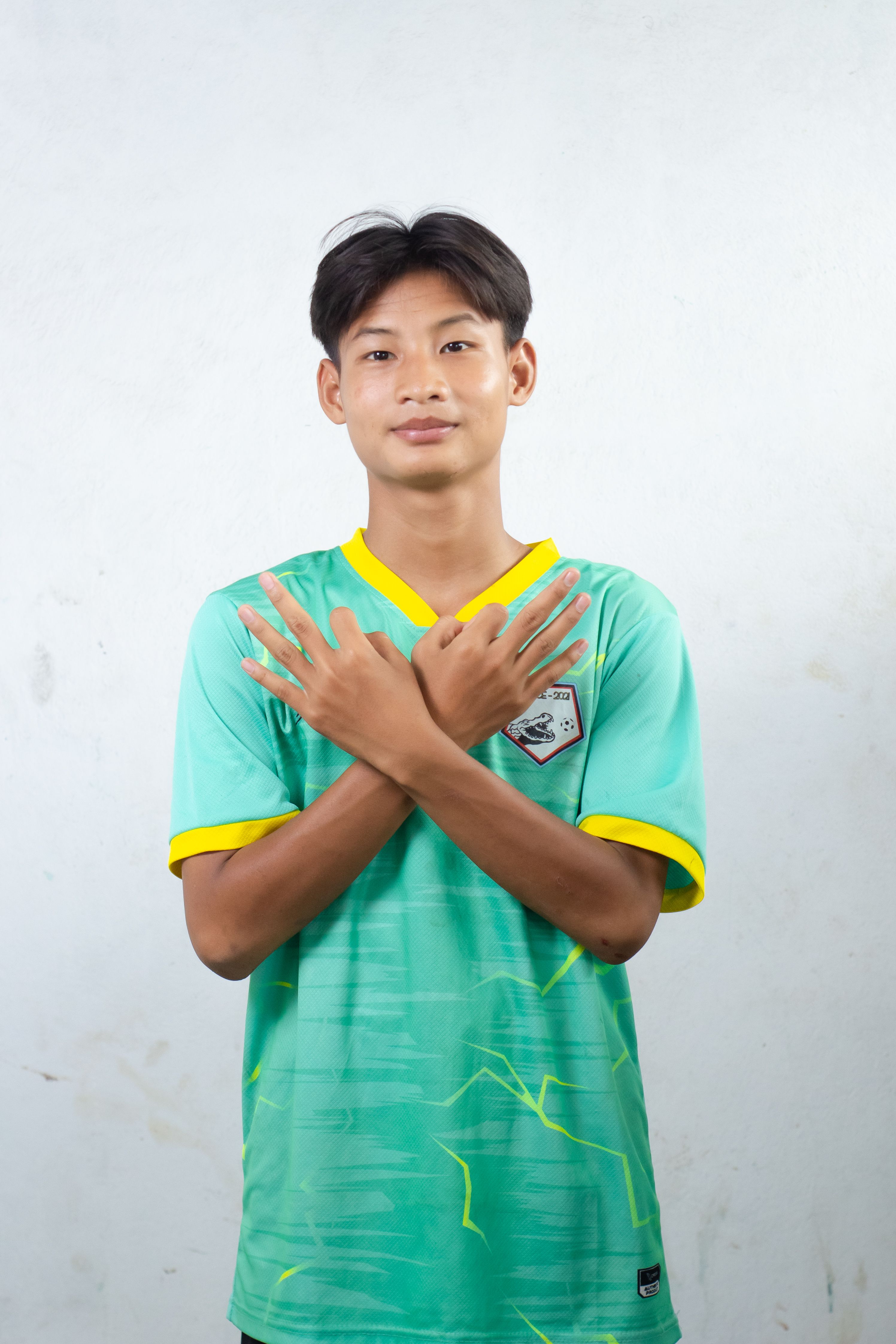 Young Athlete in Green Sports Jersey Pose