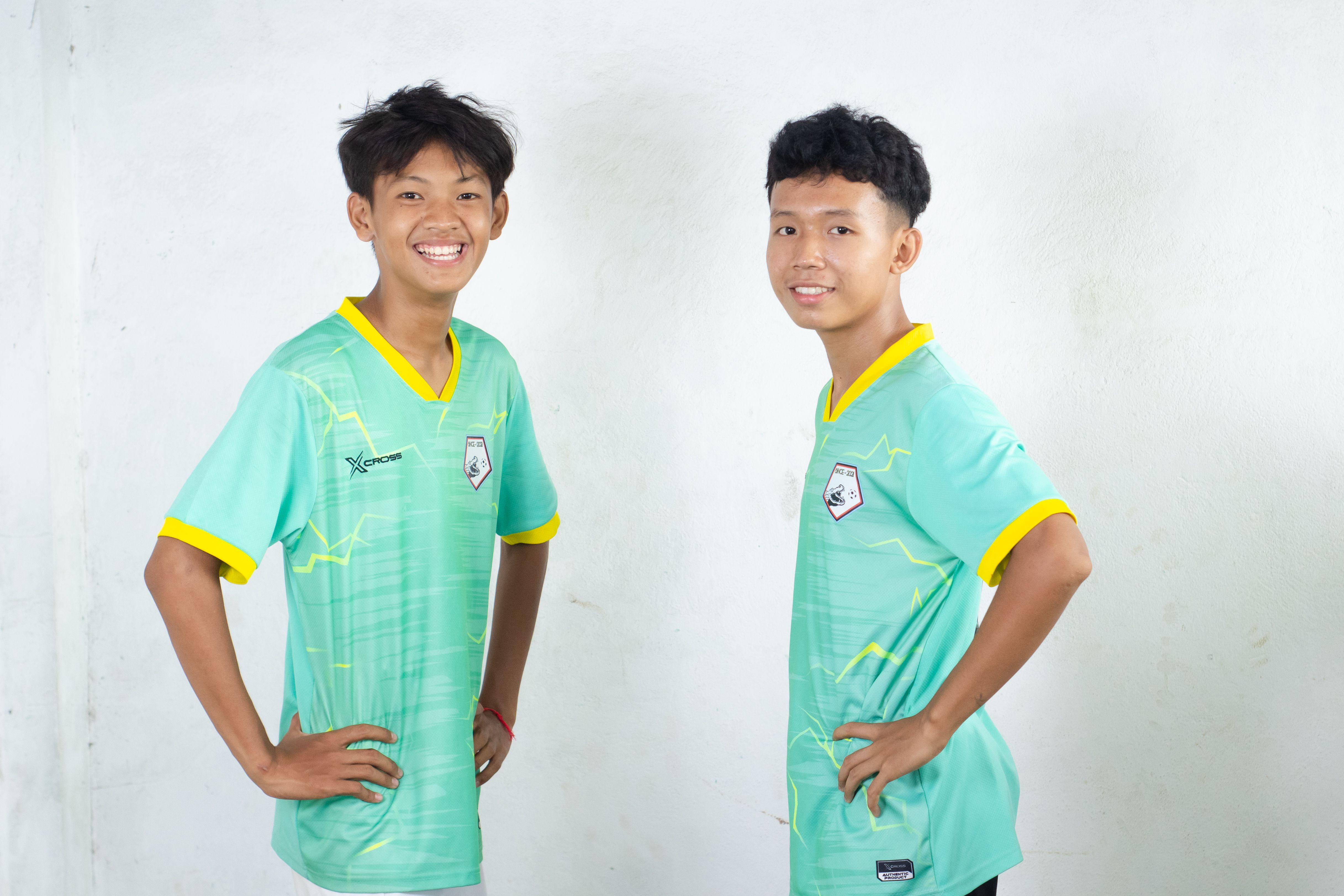 Cheerful Football Players Posing Indoors