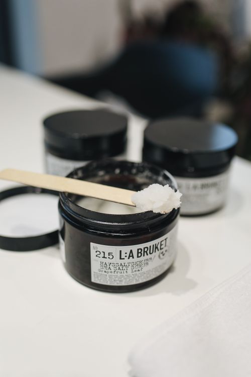 Free L:A Bruket sea salt scrub jar with spatula, perfect for skincare routines. Stock Photo