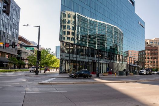 Street view of a modern glass building in downtown area with reflections, urban life, and city vibes.