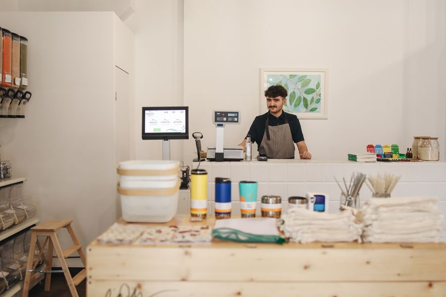A shop owner arranging goods on a counter