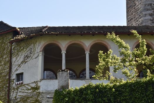 Classic Italian architecture with arches and ivy in Trentino-Alto Adige.