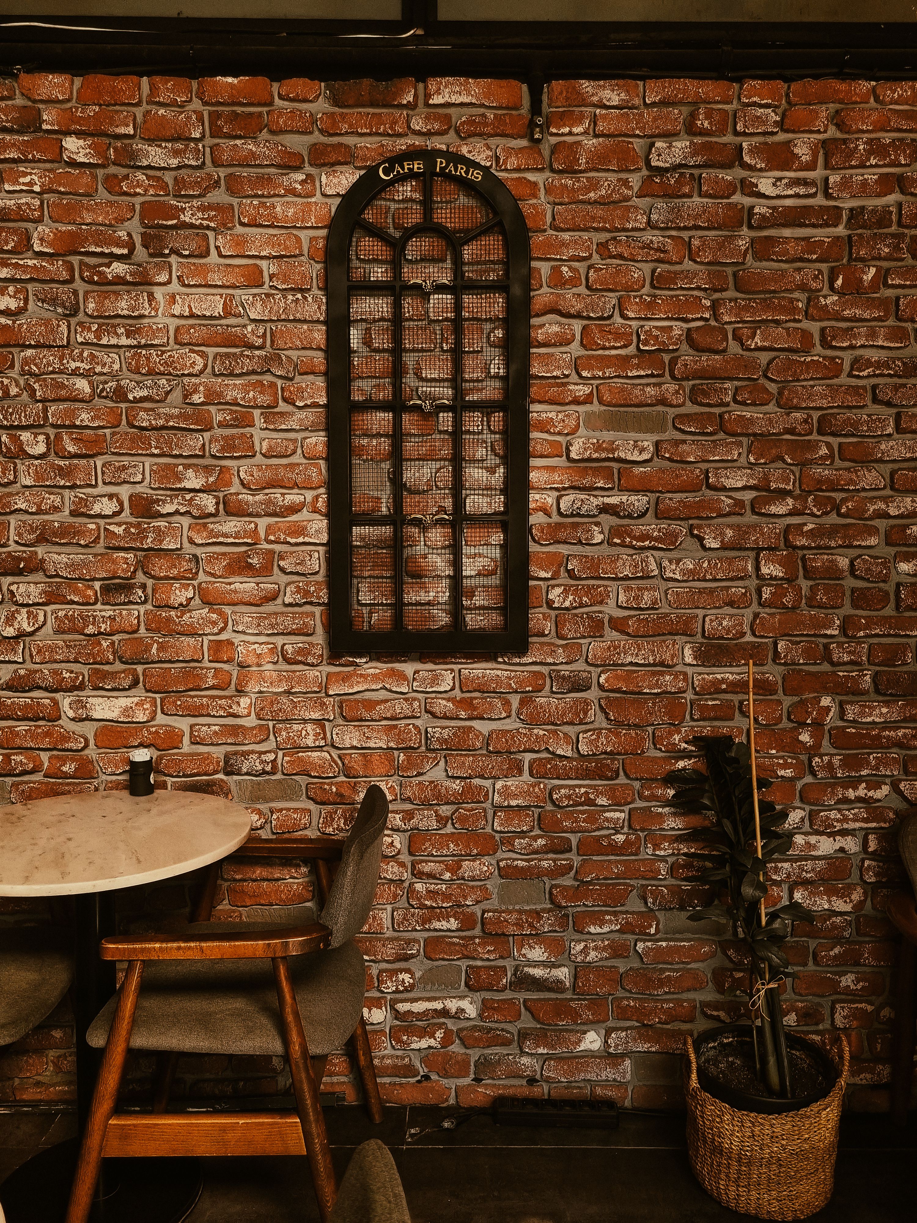 Cozy Cafe Interior with Exposed Brick Wall · Free Stock Photo