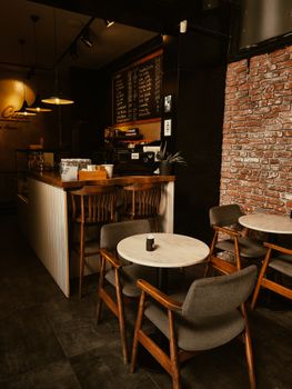 A warm-toned cafe in Ankara with wooden decor and brick walls, offering a cozy atmosphere.