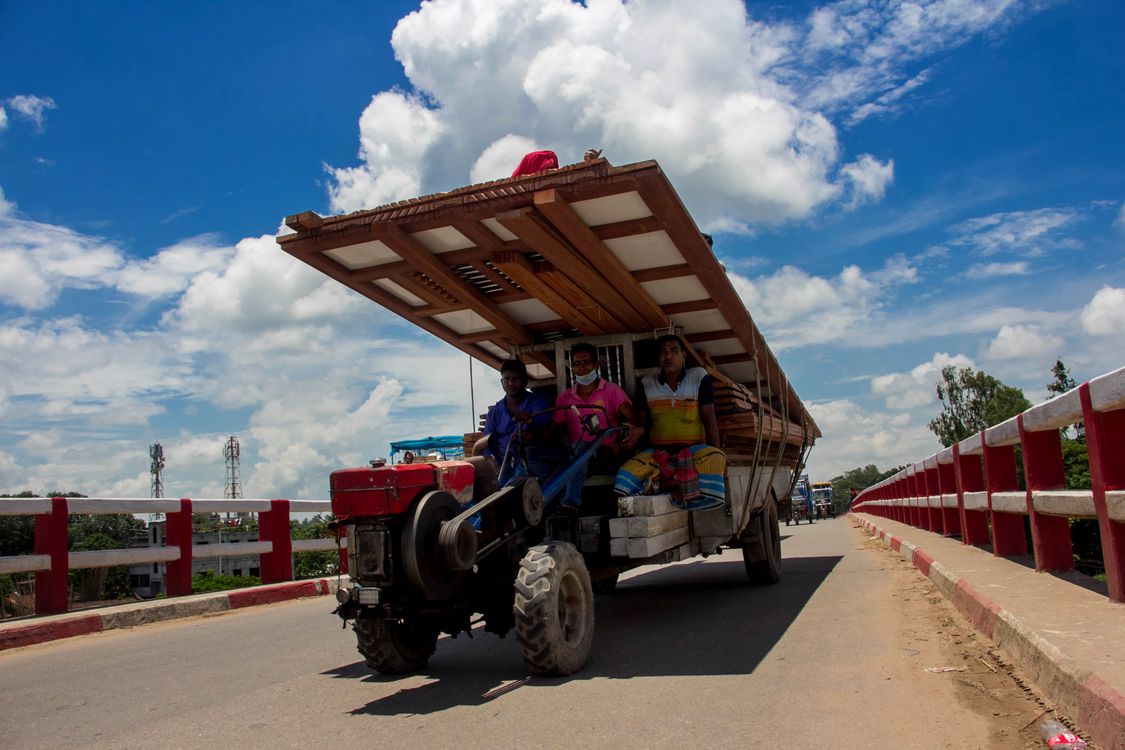 Rural Rising Vehicle Rural Transport with Makeshift Roof on Bridge · Free Stock Photo