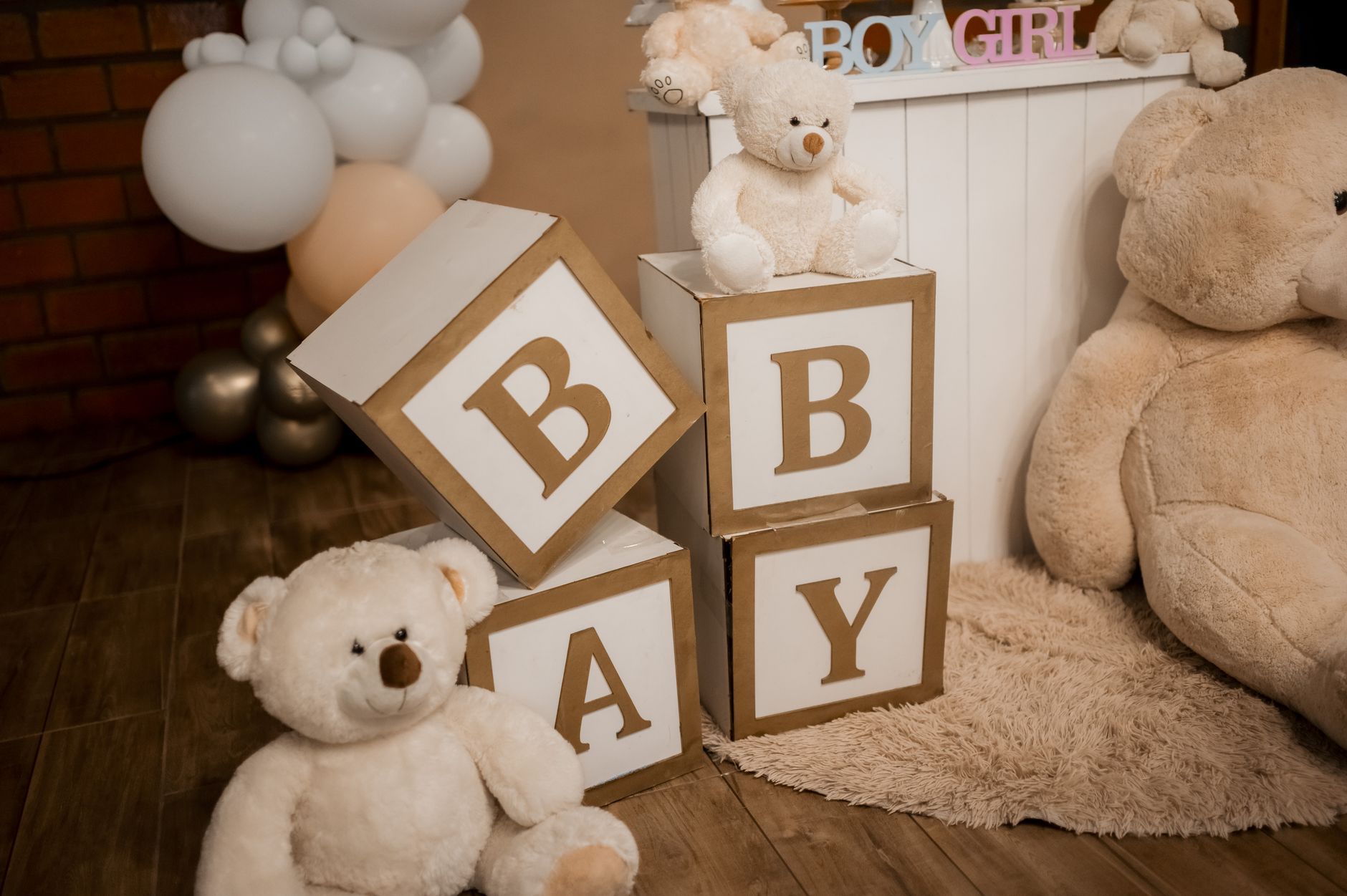 Warm and cozy baby shower setup with teddy bears and decorative blocks spelling 'BABY'.