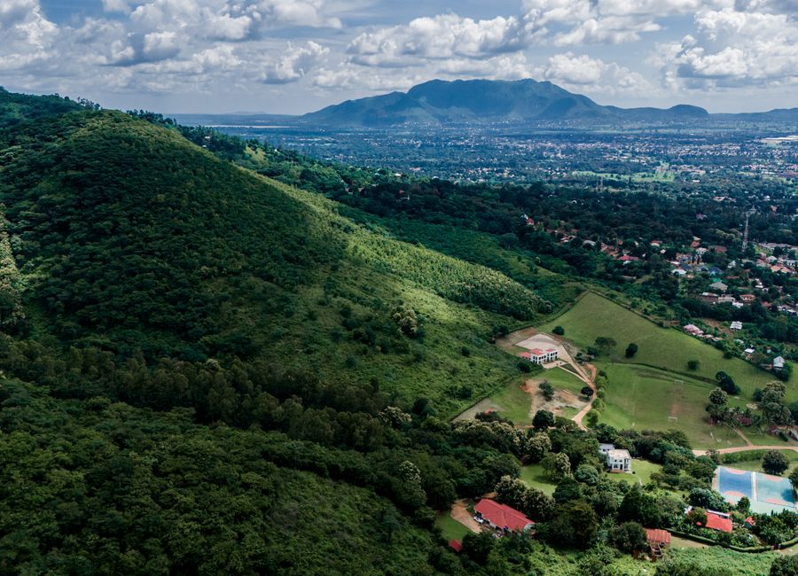 Scenic aerial view of the lush Morogoro Region, Tanzania, featuring sprawling greenery and distant mountains.
