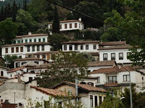 Free Charming Ottoman-style houses nestled in a lush mountain village. Stock Photo