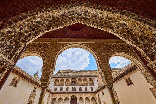 Explore the stunning arches and detailed patterns of traditional Andalusian architecture in this historic Spanish palace.
