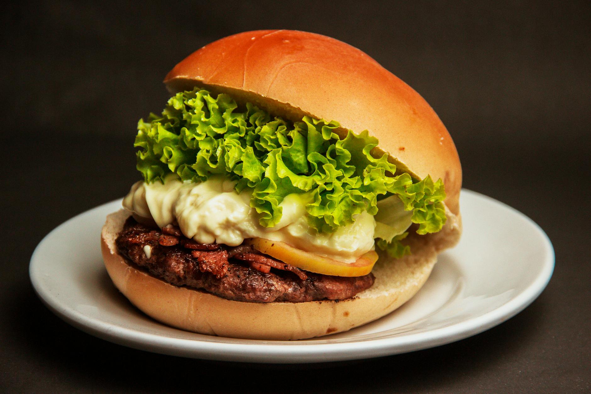 Burger With Lettuce and Cheese on a White Plate · Free Stock Photo