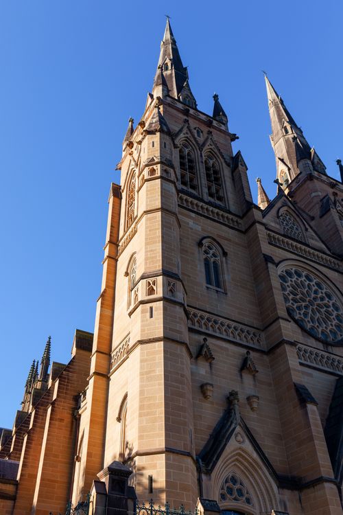 Free A view of St. Mary's Cathedral in Sydney, showcasing its Gothic architecture against a clear blue sky. Stock Photo