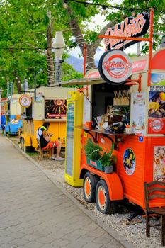 Vibrant food trucks offering diverse culinary delights in a lively outdoor setting, perfect for a summer day.