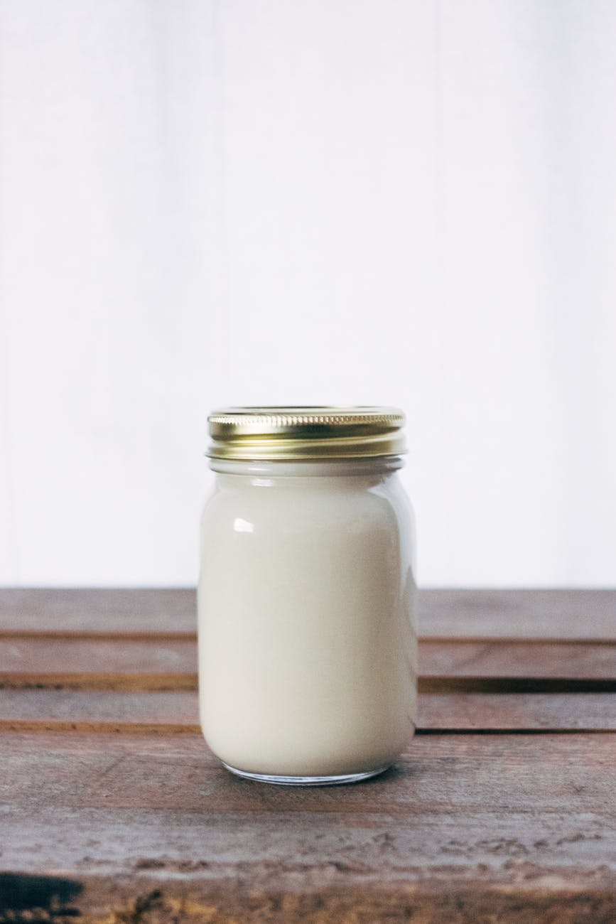 a bottle of curd kept on a brown table