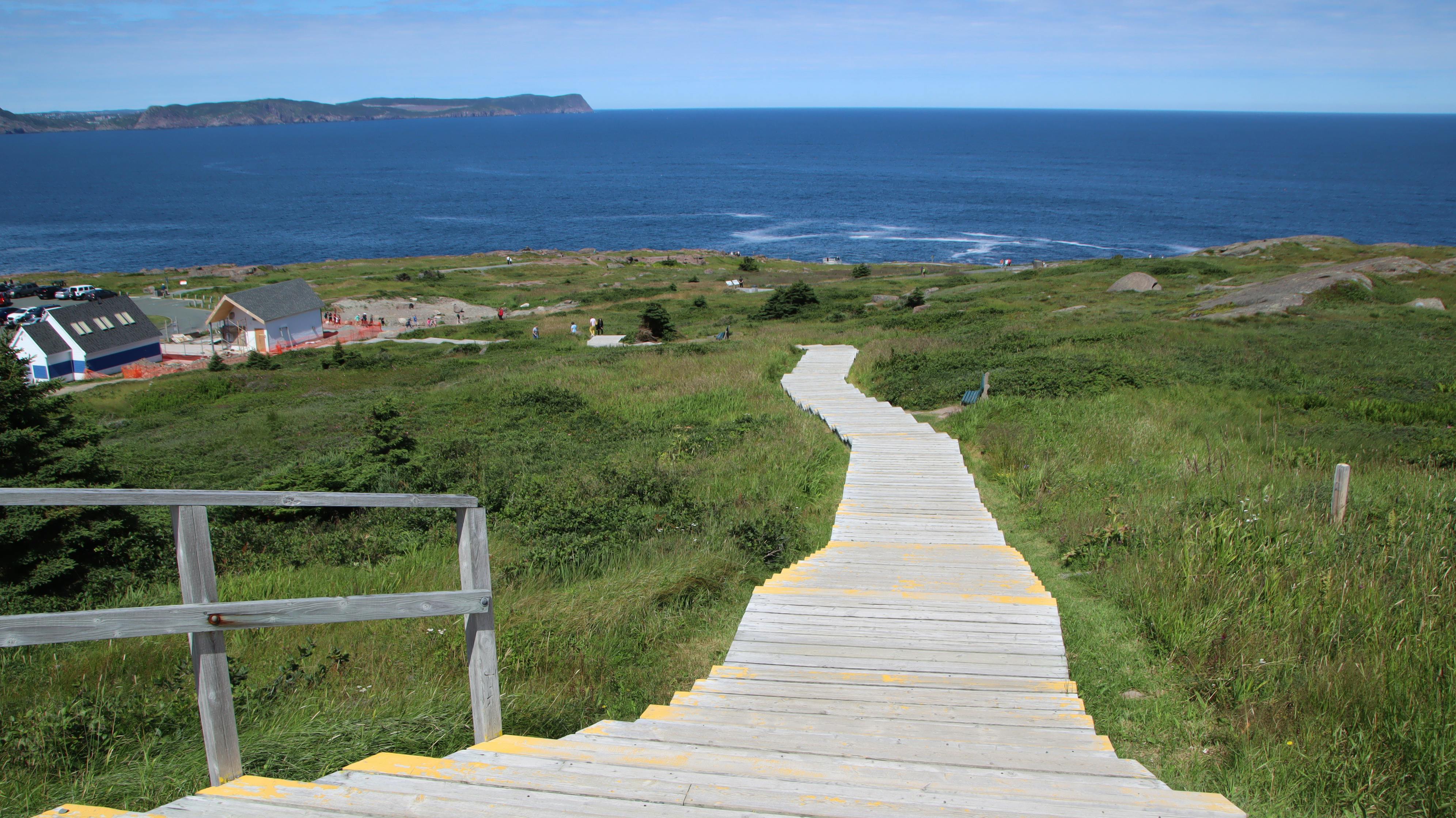 Person drinking water and eating a bowl of oats with fruit