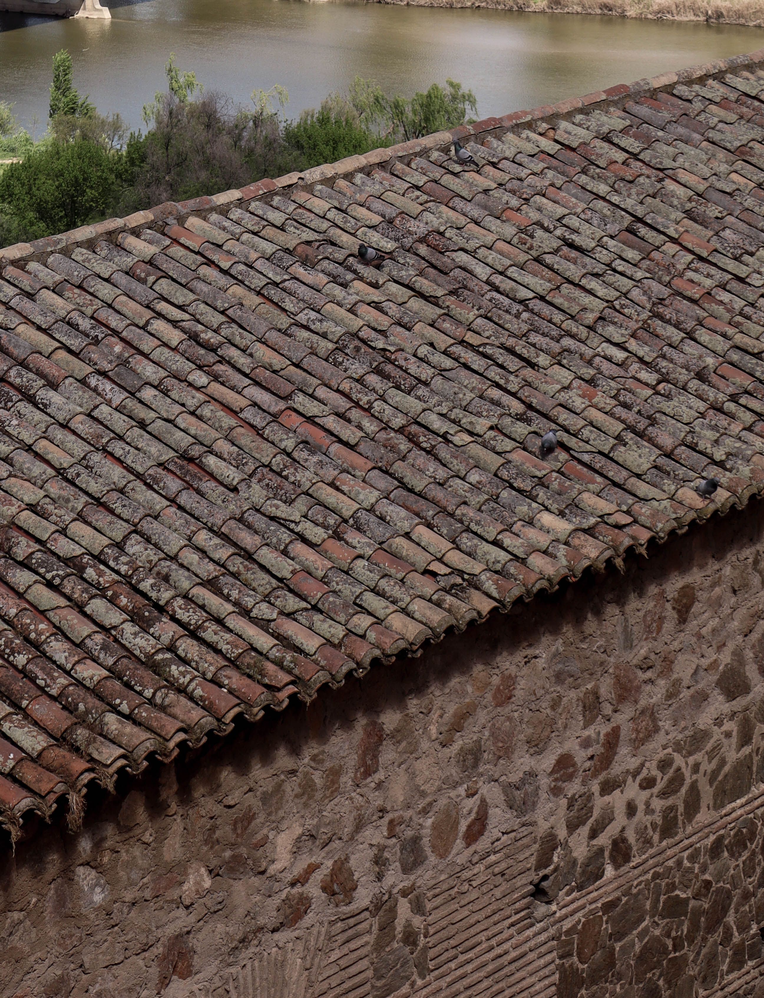 Historic stone roof in Toledo, Spain overlooking the river. Perfect for architecture and travel stock photography.