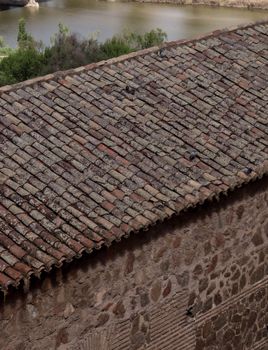 Historic stone roof in Toledo, Spain overlooking the river. Perfect for architecture and travel stock photography.