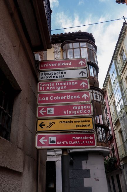 Directional signs in Toledo's historic district, showcasing local landmarks and attractions.