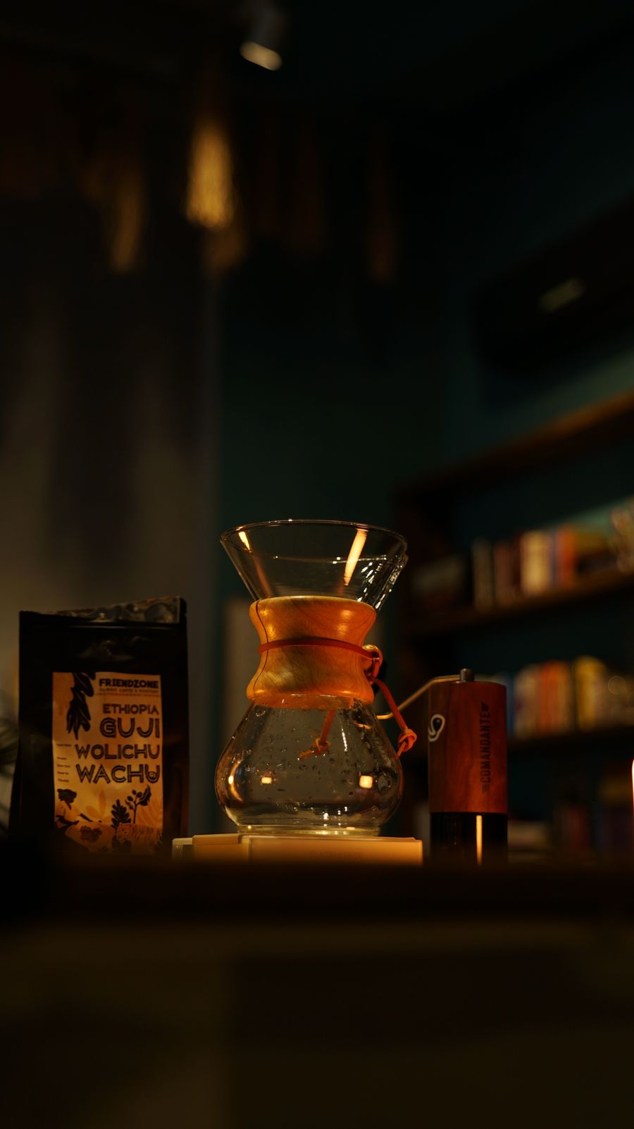 A Chemex brewer and cups on a cafe counter