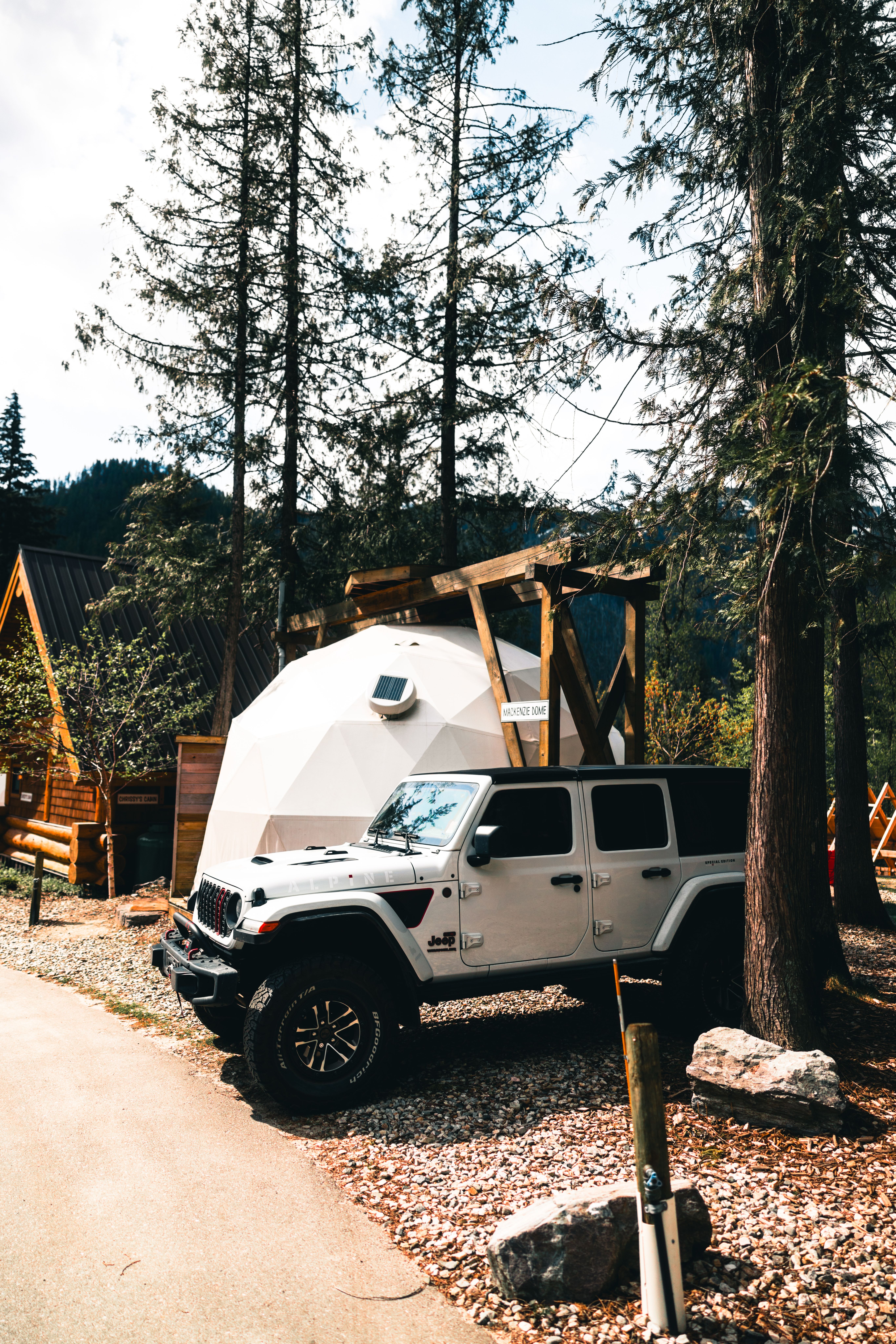 Adventure Vehicle Parked at Geodesic Dome in Forest · Free Stock Photo