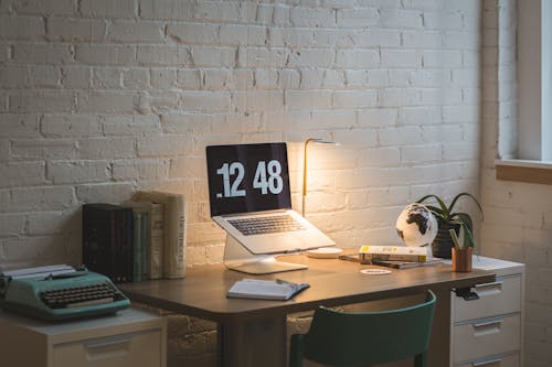 Macbook on Desk Beside Table Lamp