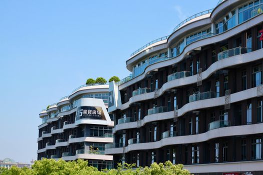 Contemporary building with sleek design at Linpao Plaza under clear blue sky.