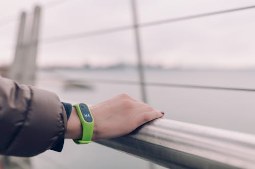 Person Wearing Green Fitness Band