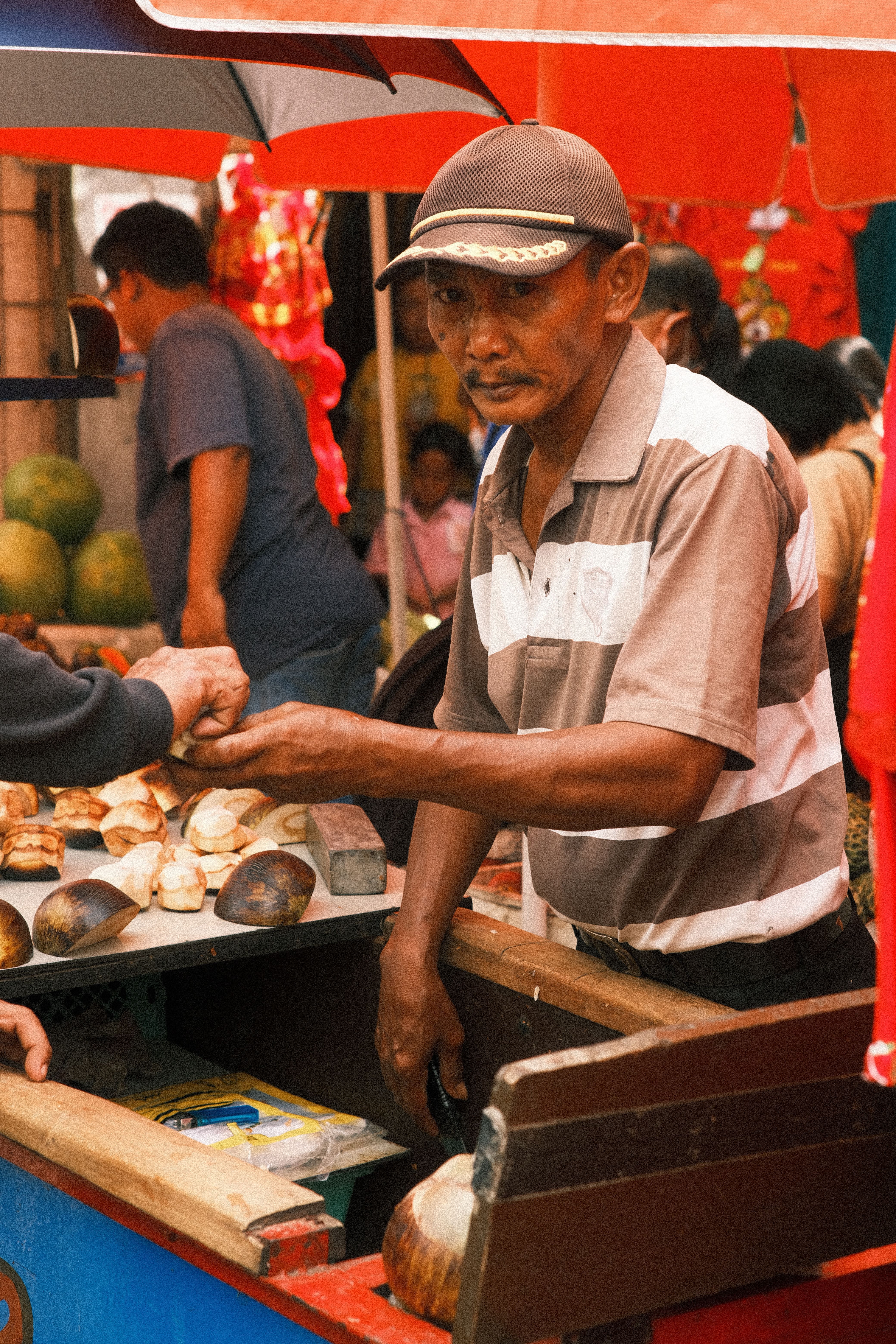 Street Vendor at Outdoor Market Stall · Free Stock Photo